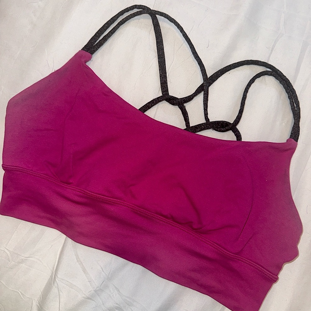 Magenta sports bra with grey criss-cross straps